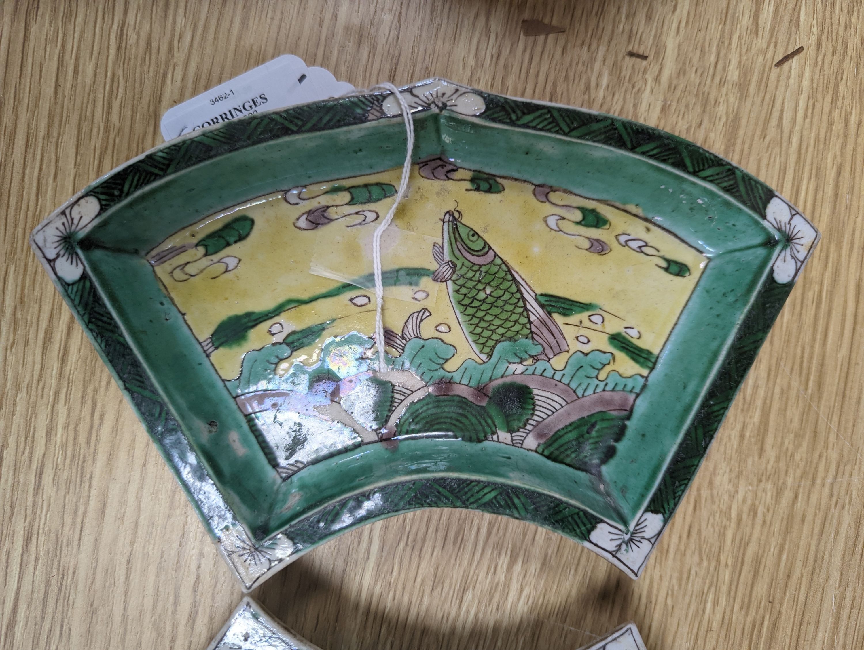 A pair of Chinese famille verte biscuit fan-shaped sweetmeat dishes, Kangxi, 20 cms wide.
